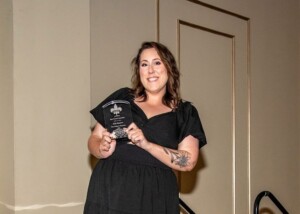 Kelly Massicot of Renaissance Publishing receiving award at Press Club of New Orleans Awards